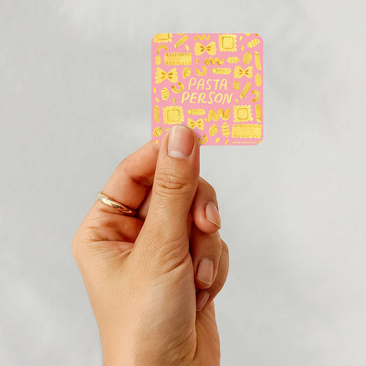 hand holding "pasta person" sticker 