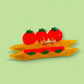 hair claw shaped like a penne pasta with 3 tomatoes on top 