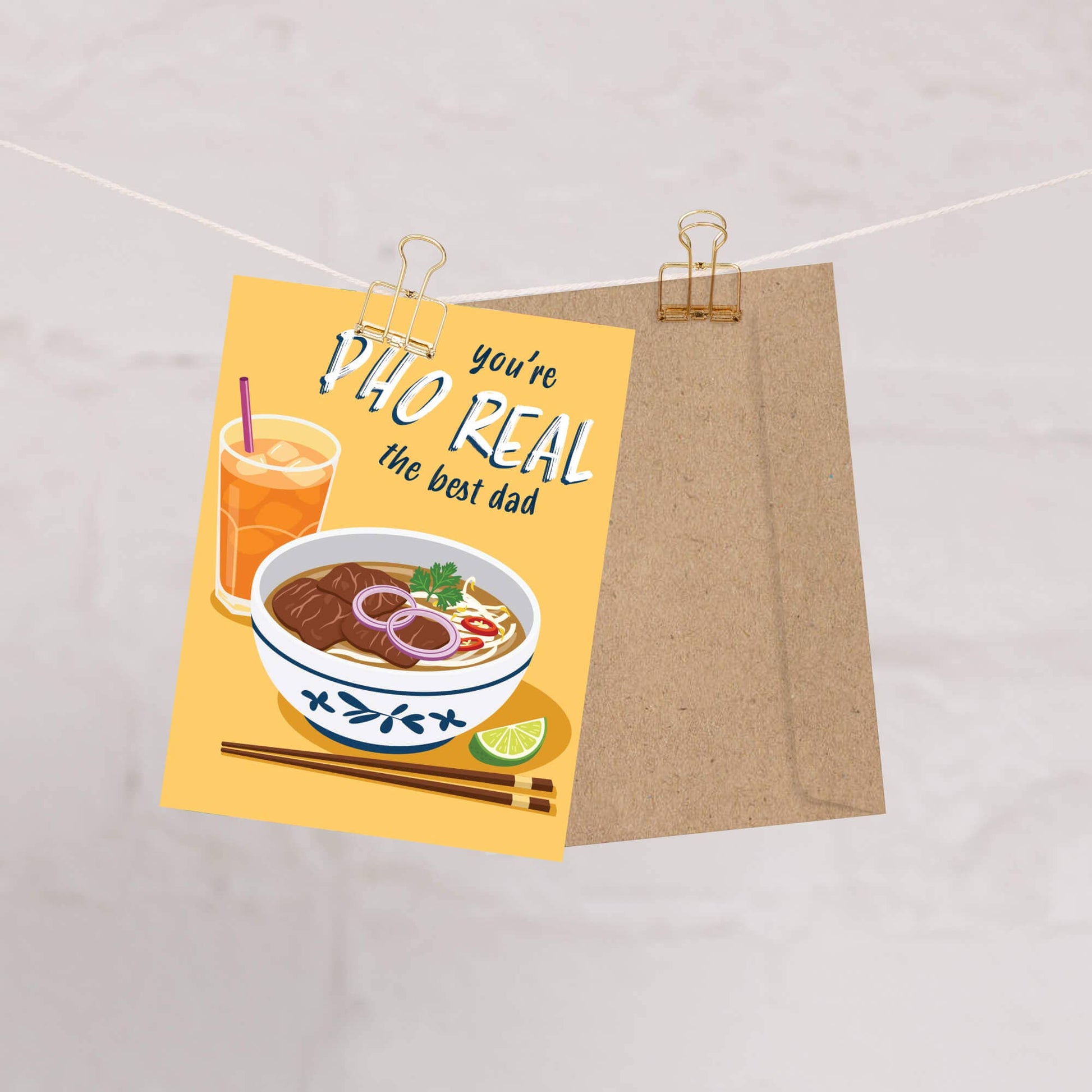 Greeting card with a bowl of soup and a drink, text 'you're the best dad', on a beige background.