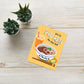 Greeting card with pho illustration on a wooden surface with plants