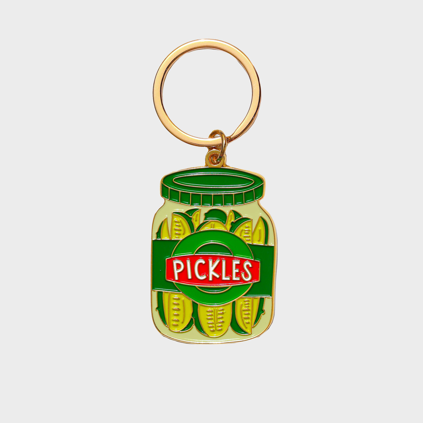 Keychain shaped like a jar of pickles with a gold ring on a white background
