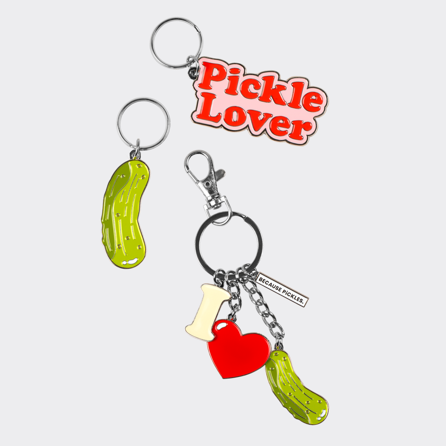 three pickle-themed keychains one with a 'Pickle Lover' text on a light gray background.