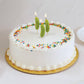three, pickle shaped birthday candles on a cake, all lit 