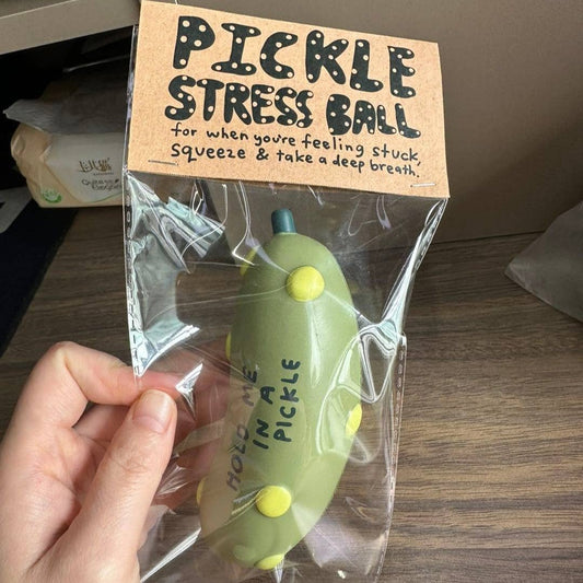 pickle stress ball with text that reads "hold me in a pickle" in plastic packaging