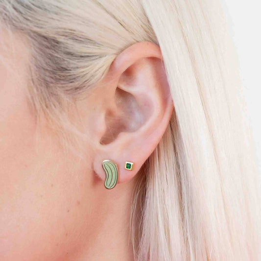 One pickle stud earring on ear lobe