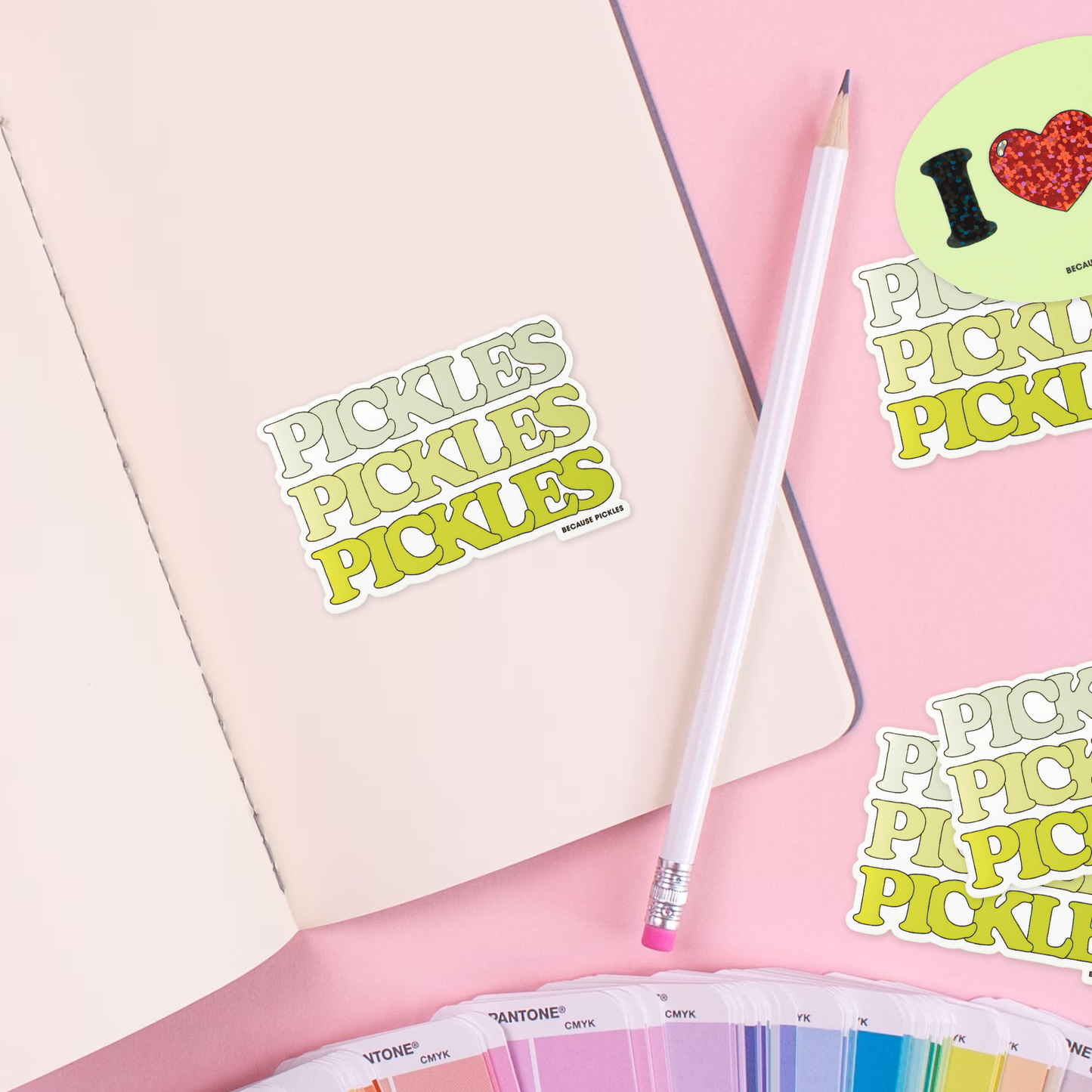 Stickers with 'PICKLES' text on a pink surface with a color swatch.