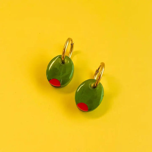 Pimento olive earrings -- made out of acrylic and on a yellow background 
