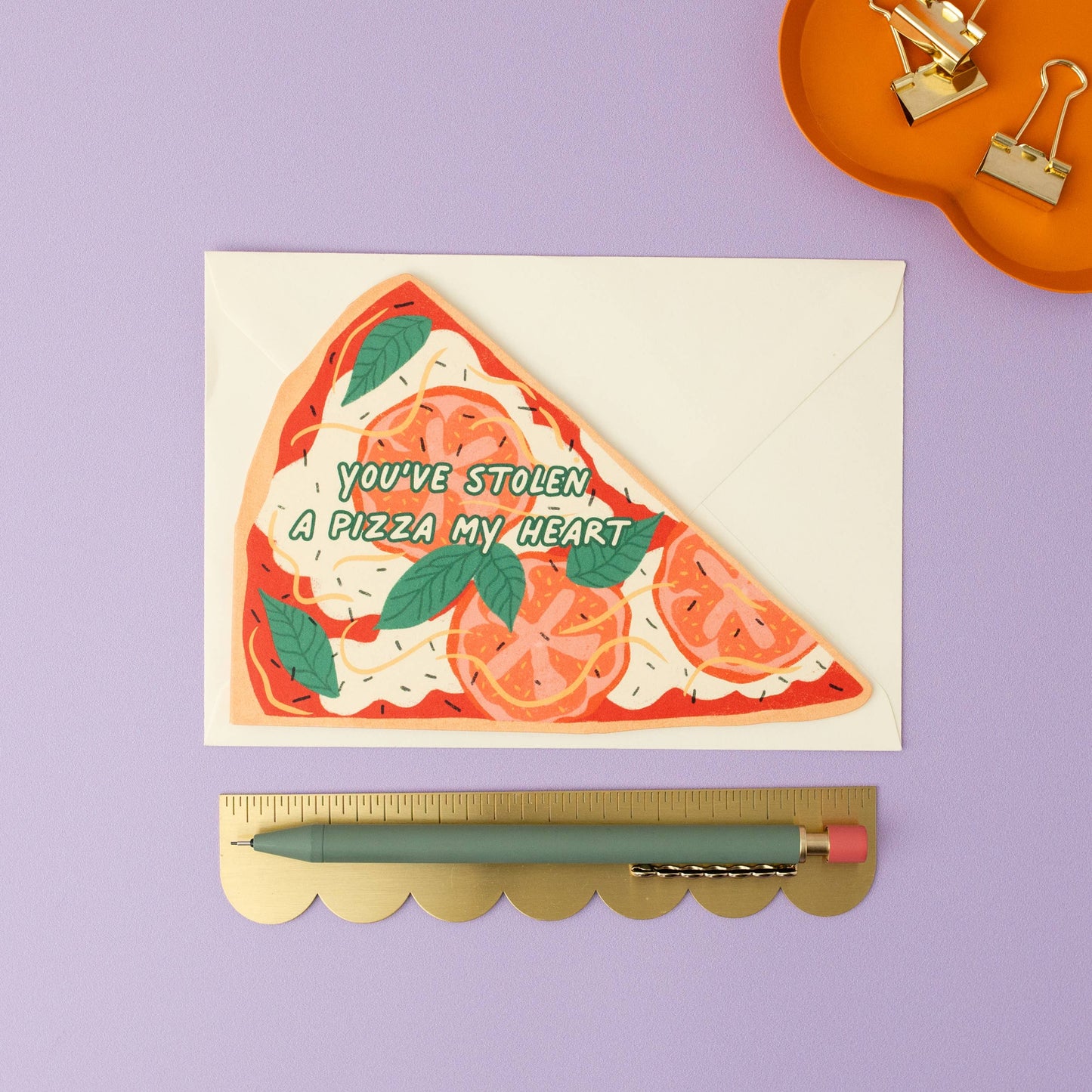 die-cut greeting card in the shape of a margherita pizza slice. Text on top reads "you've stolen a pizza my heart" 