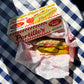 Hot dog with Portillo's branding on a checkered tablecloth