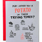 Card with humorous potato-themed text and illustrations on a gray background with red envelope.