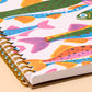 Notebook with colorful fish pattern on a beige background