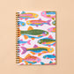 Notebook with colorful fish pattern on a beige background