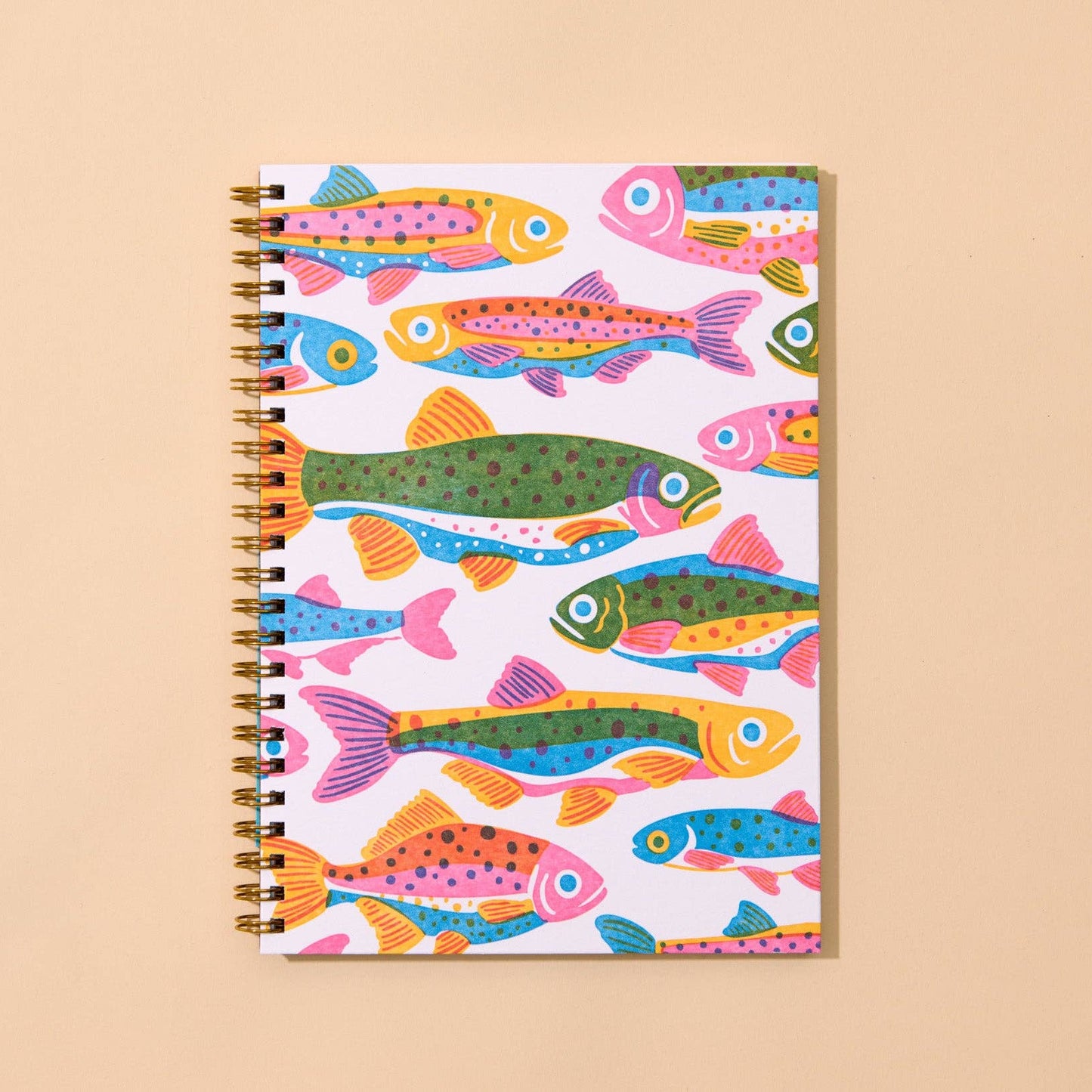 Notebook with colorful fish pattern on a beige background