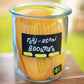 Jar filled with rigatoni shaped bookmarks on a wooden surface