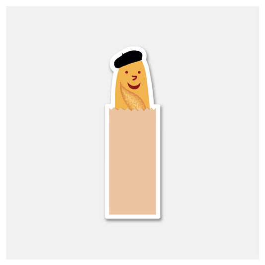 Smiley faced baguette wearing a beret inside of a brown paper bag -- sticker 