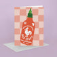 Valentine's Day card with a rooster hot sauce bottle illustration on a checkered background