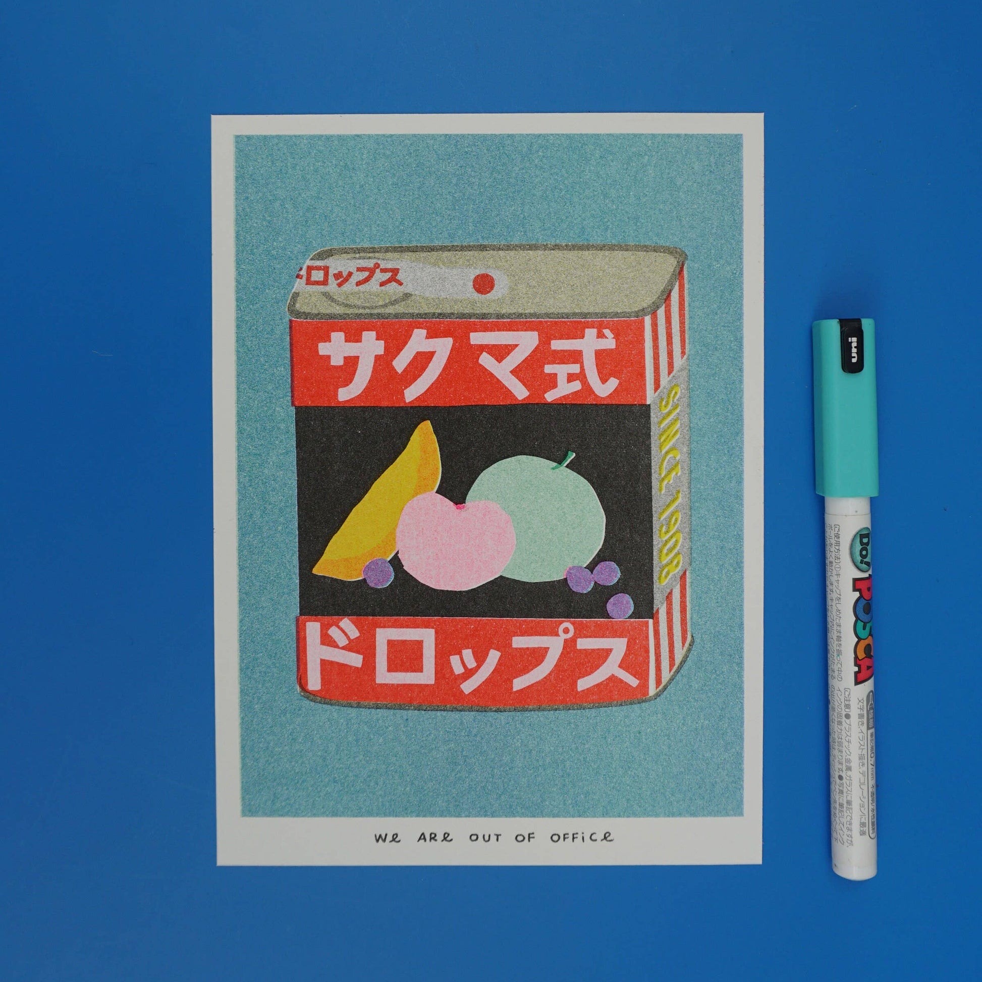 Vintage-style product packaging illustration of Sakuma Drops, with Japanese text on a blue background, accompanied by a marker for scale.