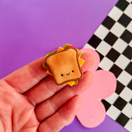 mini smiley faced sandwich magnet with cheese, tomato and lettuce