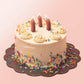 3 sausage candles on a cake