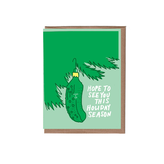 Holiday card with pickle ornament illustration and text "hope to see you this holiday season" on green background