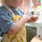 Children size apron with banana print all over