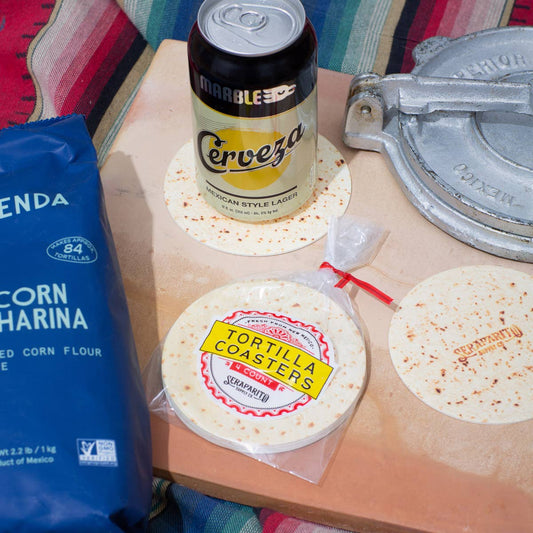 full set of tortilla coasters on table along with two individual ones being used