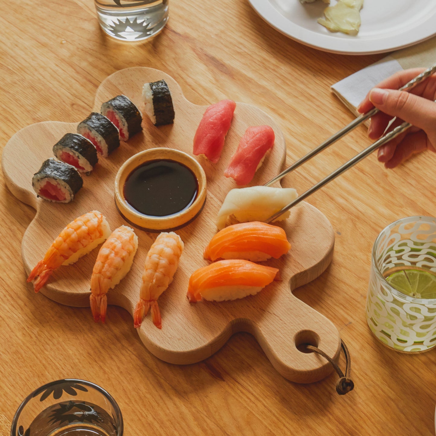 Floral shaped cutting board with sushi on it 