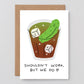 Greeting card with a cartoon pickle in a cup and text 'Shouldn't work, but we do' on a white background.
