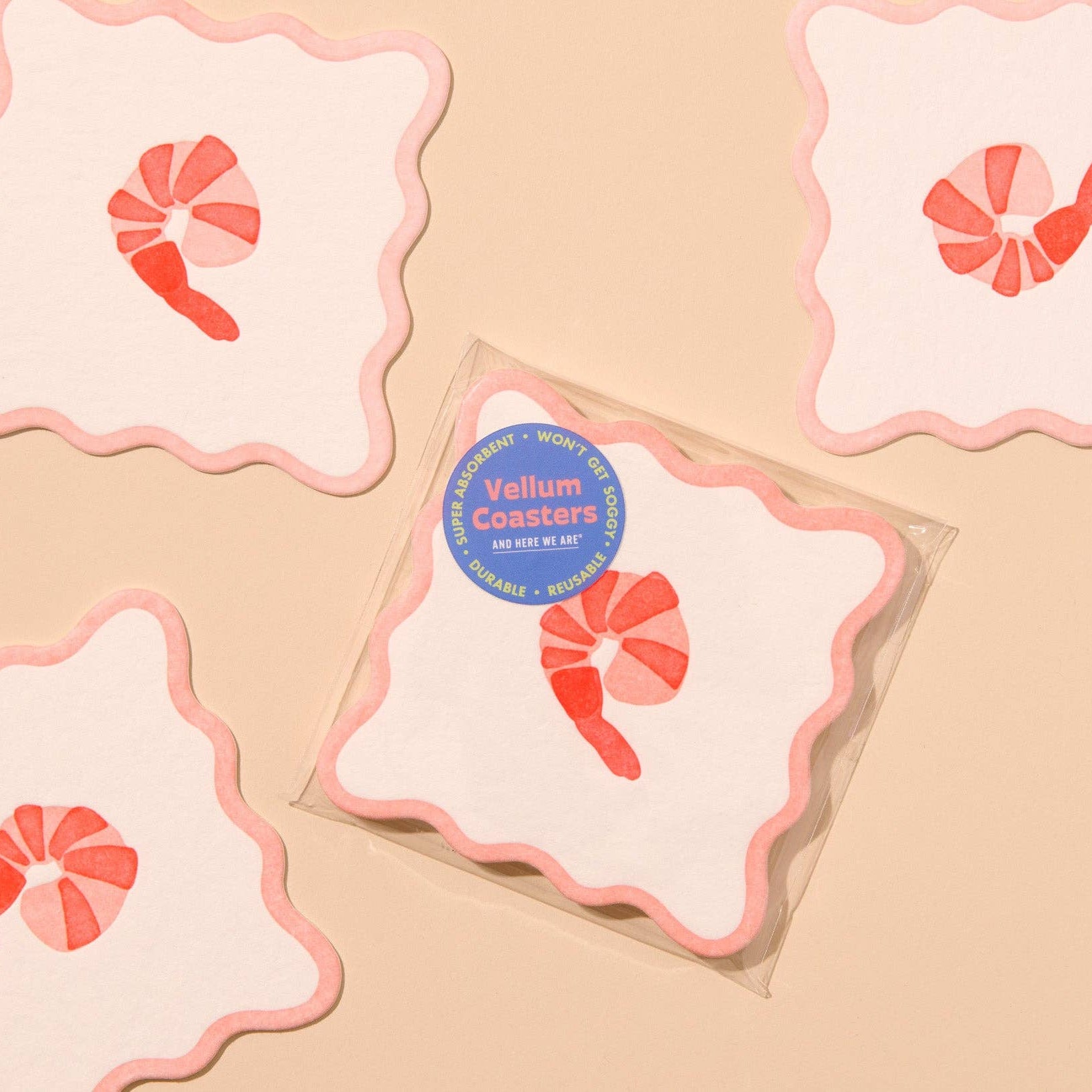 Vellum coasters with shrimp design on a beige background