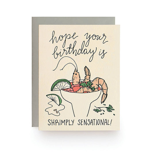 Birthday card with shrimp cocktail illustration and text 'hope your birthday is shrimply sensational!' on a beige background.