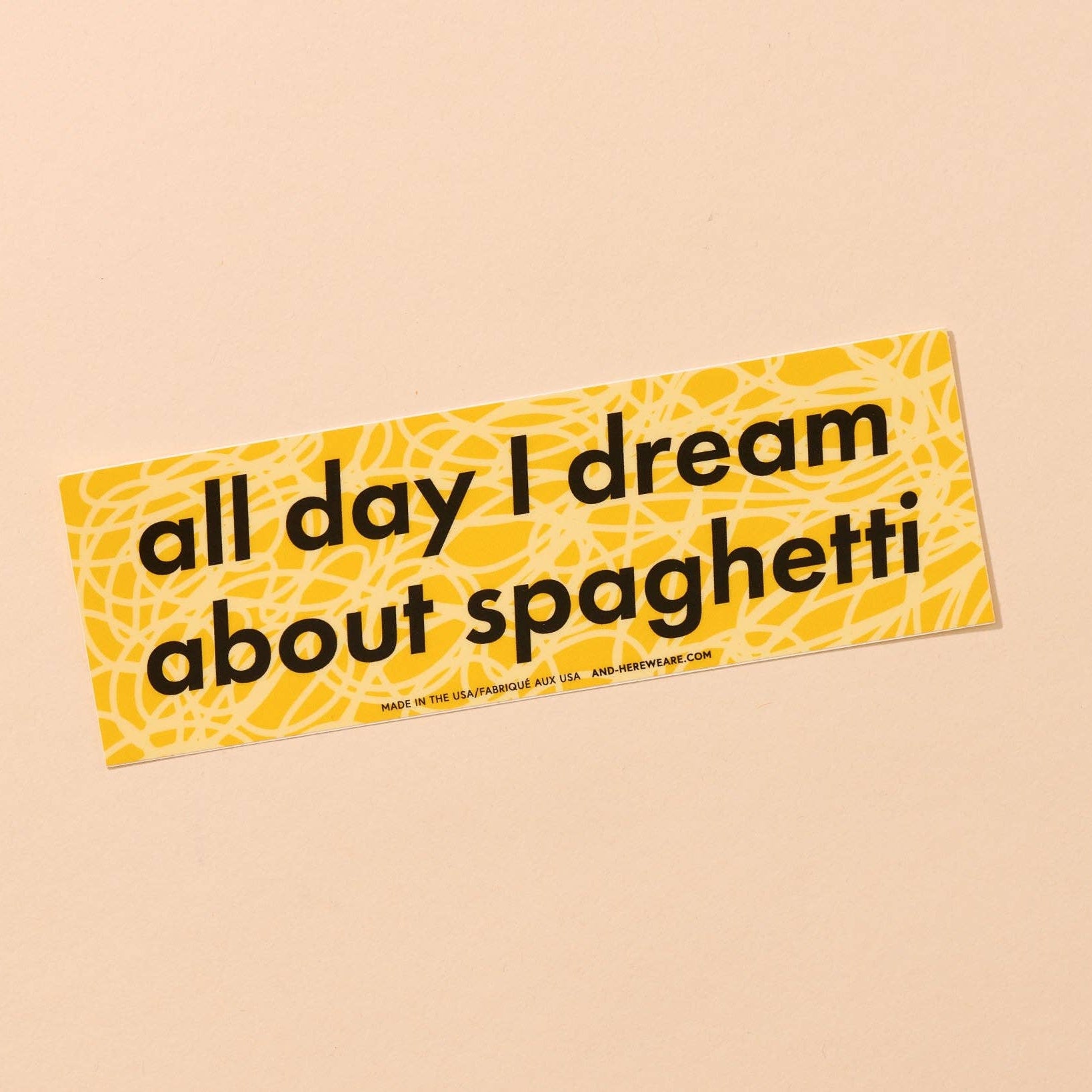 yellow bumper sticker that reads "all day I dream about spaghetti" 