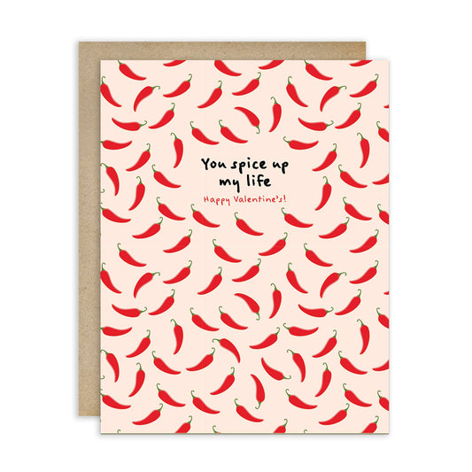 Greeting card with red chili pepper pattern and text "you spice up my life. Happy Valentine's!" on a beige background