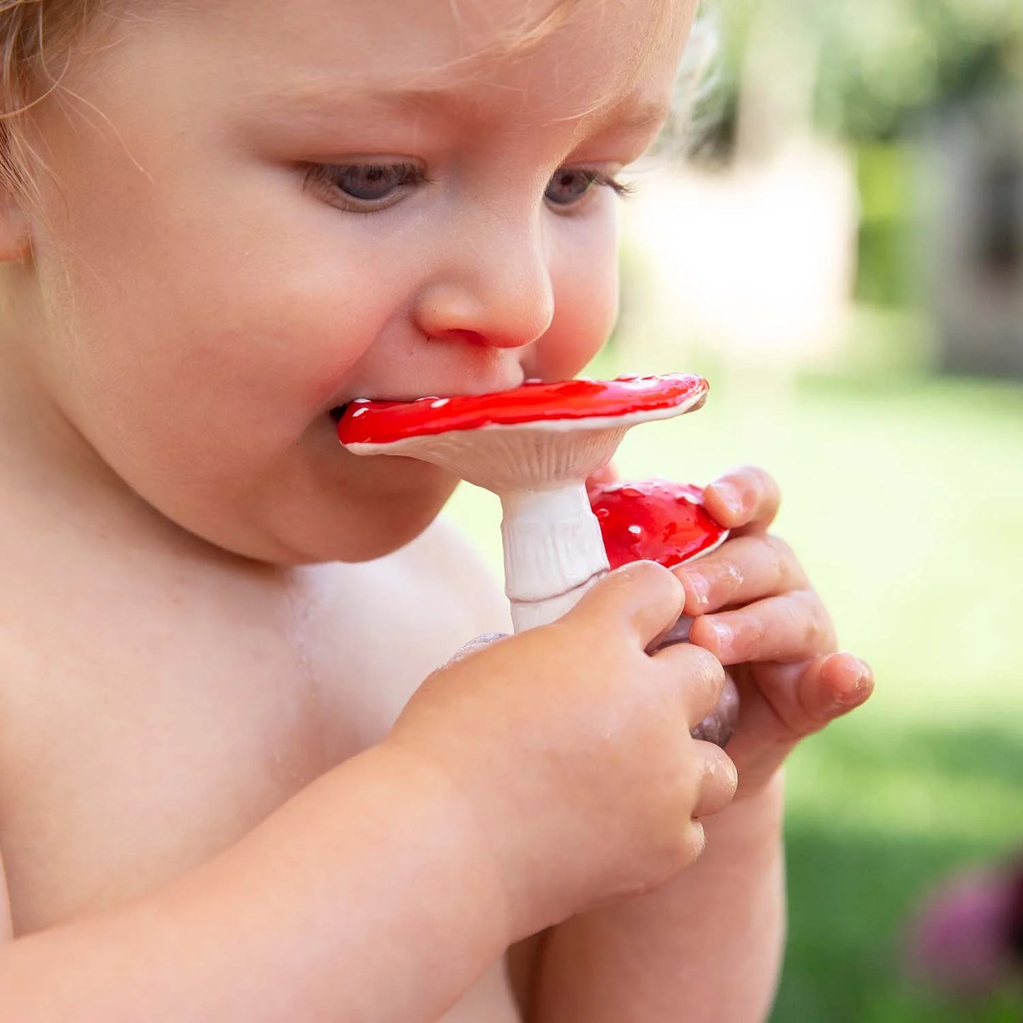 Photo of baby teething on mushroom baby toy.