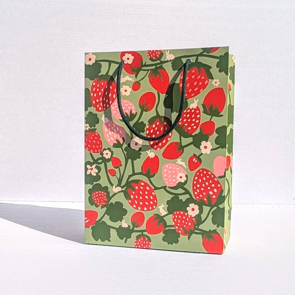 Gift bag with strawberry pattern on a white background
