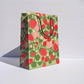 Gift bag with strawberry pattern on a white background