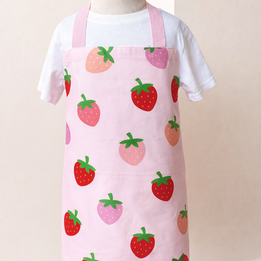 Pink apron with strawberry pattern on a mannequin against a white background