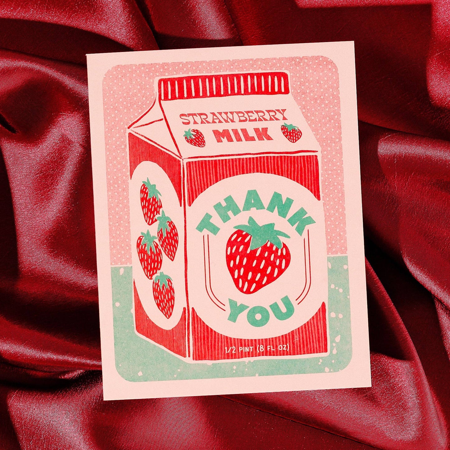 Card with strawberry milk design and 'Thank You' text on a red fabric background