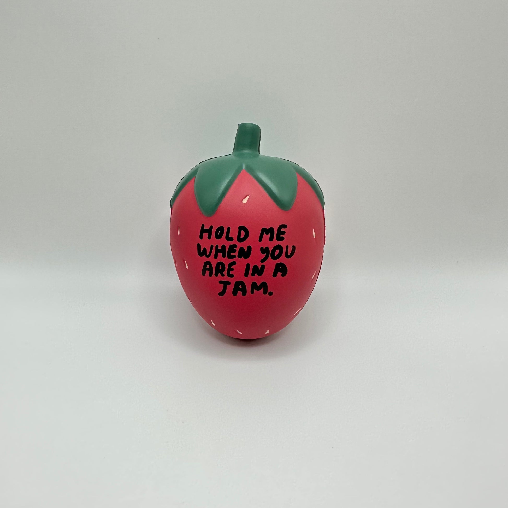 Strawberry stress ball that reads: Hold me when you are in a jam.