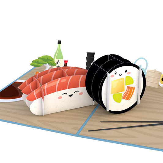 pop up greeting card featuring one piece of nigiri sushi and one piece of maki sushi, as well as a bonsai tree, sake, soy sauce and other decor items. 