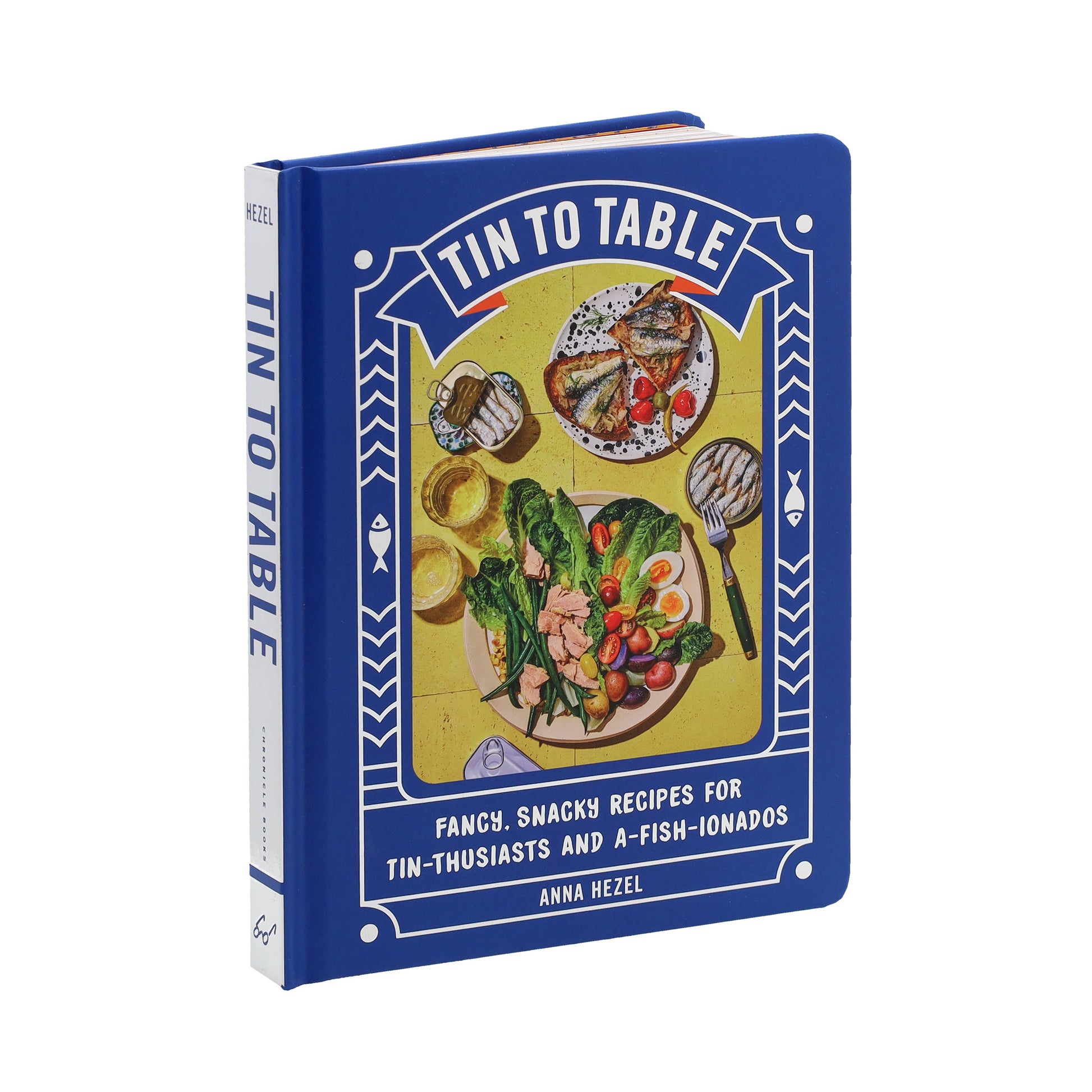 Book titled 'Tin to Table' with a colorful blue cover on a white background