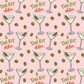 Pattern of martini glasses with olives and text 'A TINI BIT older' on a pink background.