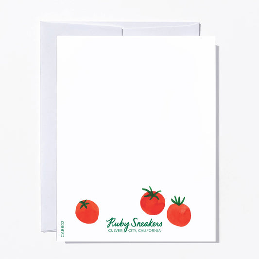 Card with red tomatoes and 'Ruby Sneakers' branding on a white background