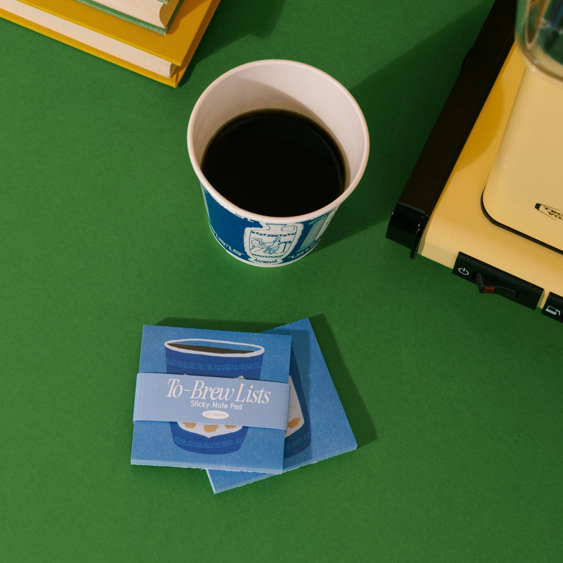 to-brew lists sticky notepads pictured on table with a cup of coffee