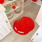 rug in the shape of a red, beefsteak tomato