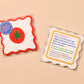 Vellum coasters with tomato design and packaging on a beige background