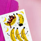 Sheet of banana and monkey stickers on a pink background