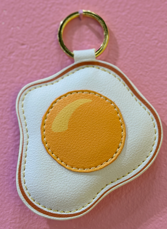 Keychain made to look like a fried egg, made of vegan leather
