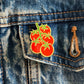 Tomato pin on a denim jacket