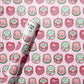 roll of wrapping paper with a continous pattern of birthdy cakes decorated in a vintage style