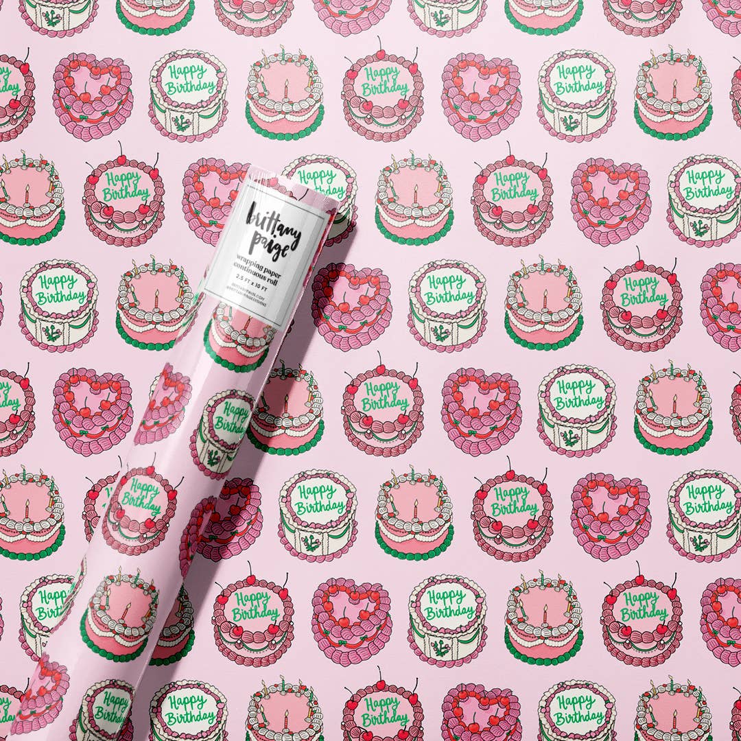 roll of wrapping paper with a continous pattern of birthdy cakes decorated in a vintage style